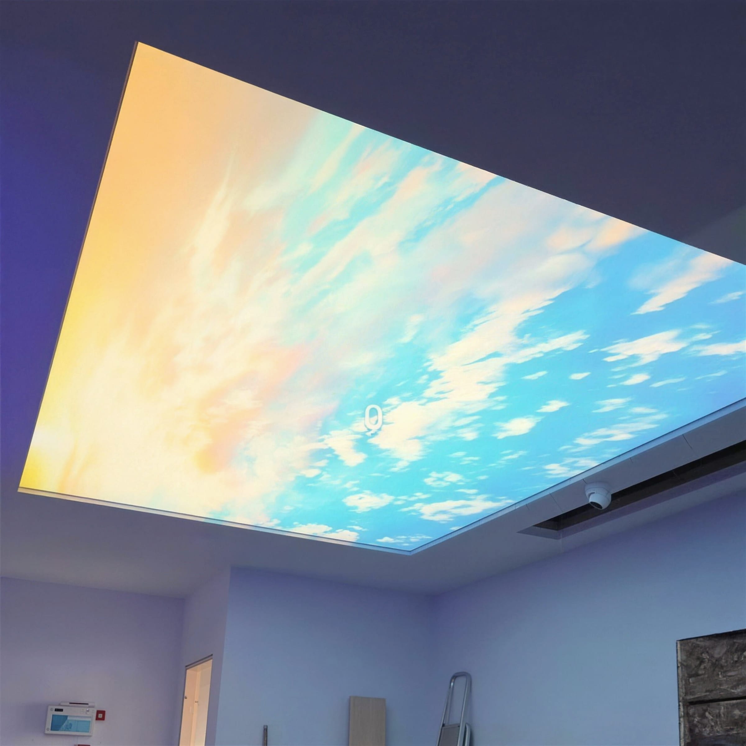 Glowing sunset sky ceiling filling the frame; the bare room below reads unfinished at the edges.