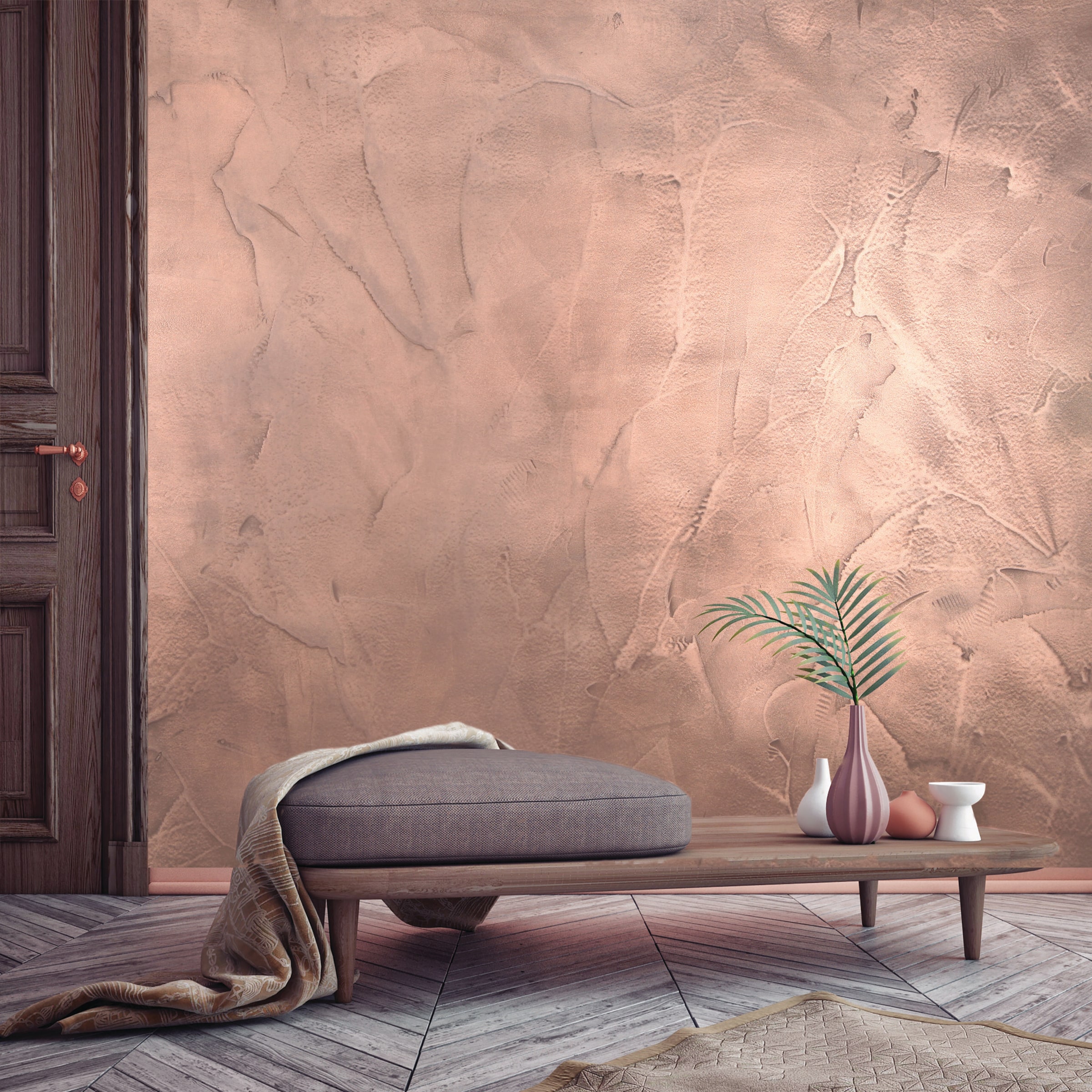 San Deco's own published image of Metalium Effect laid — a copper metal-powder wall behind a low leather chair.