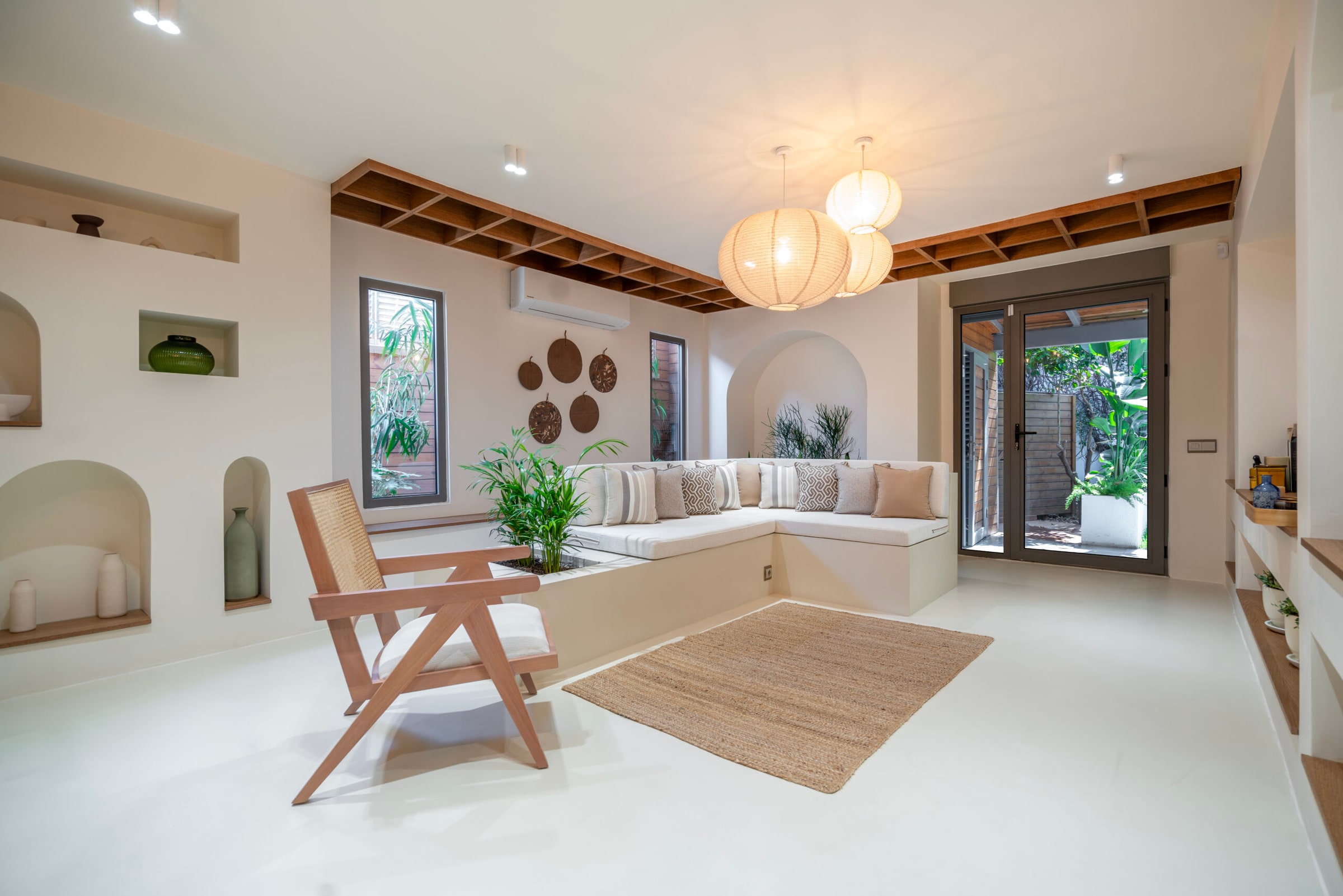 San Deco's own published image of the microcement system laid — a seamless floor and wall running unbroken through a living space.