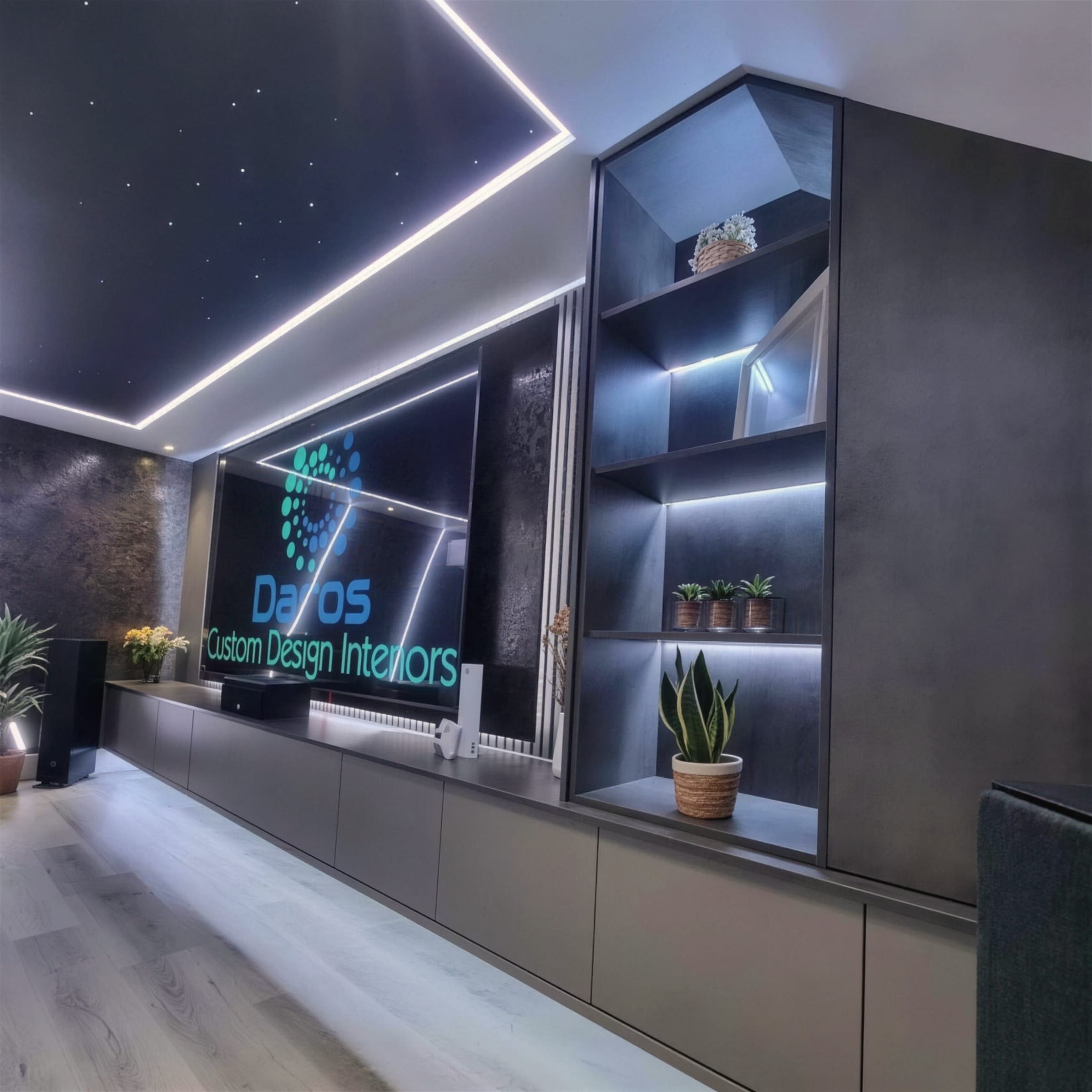 Lounge with a fibre-optic star ceiling, LED-edged bulkhead and backlit shelving beside a dark textured media wall.