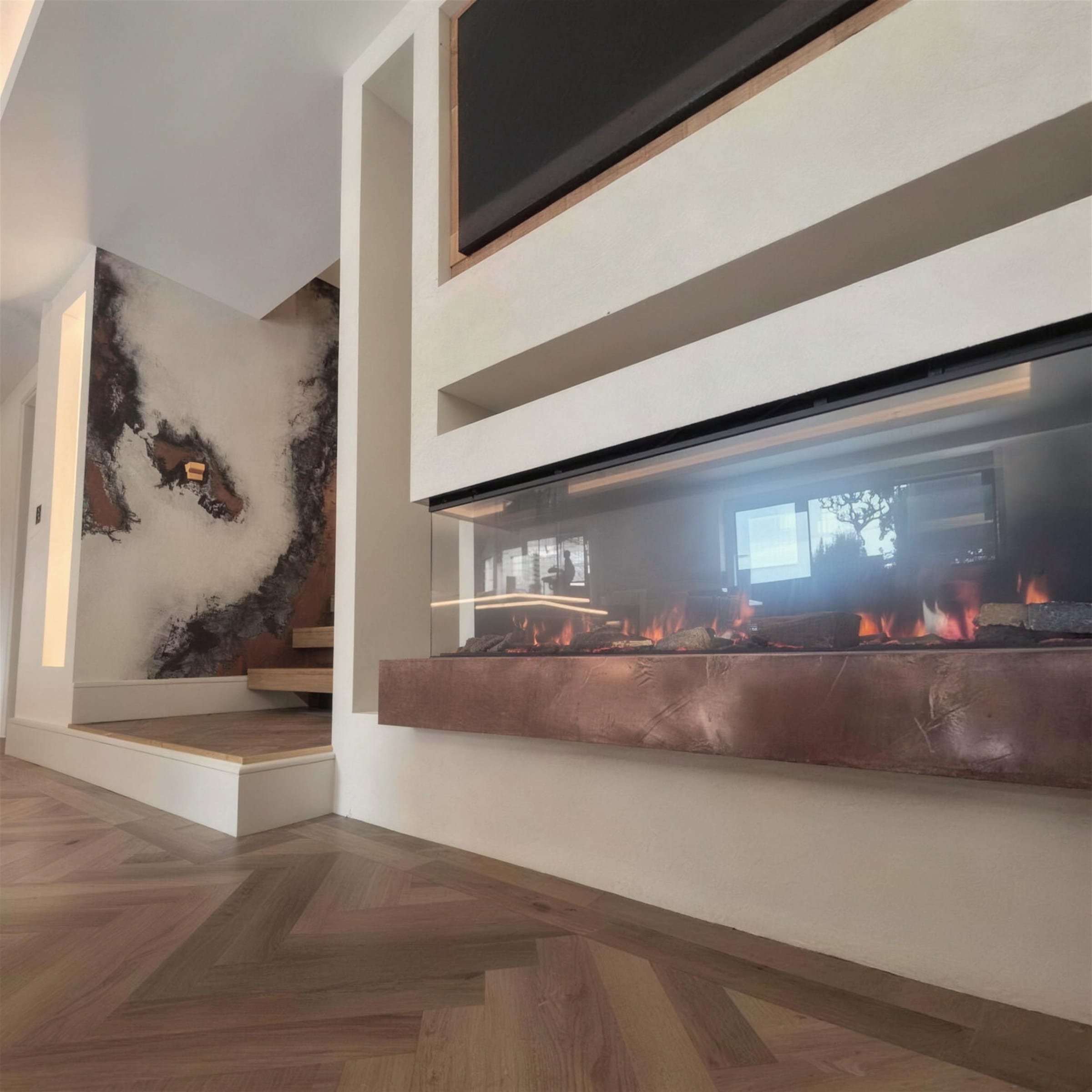 Textured plaster media wall with lit linear fire on an oxidised-copper hearth beam, with a dramatic copper-and-black metallic plaster stair wall beyond.