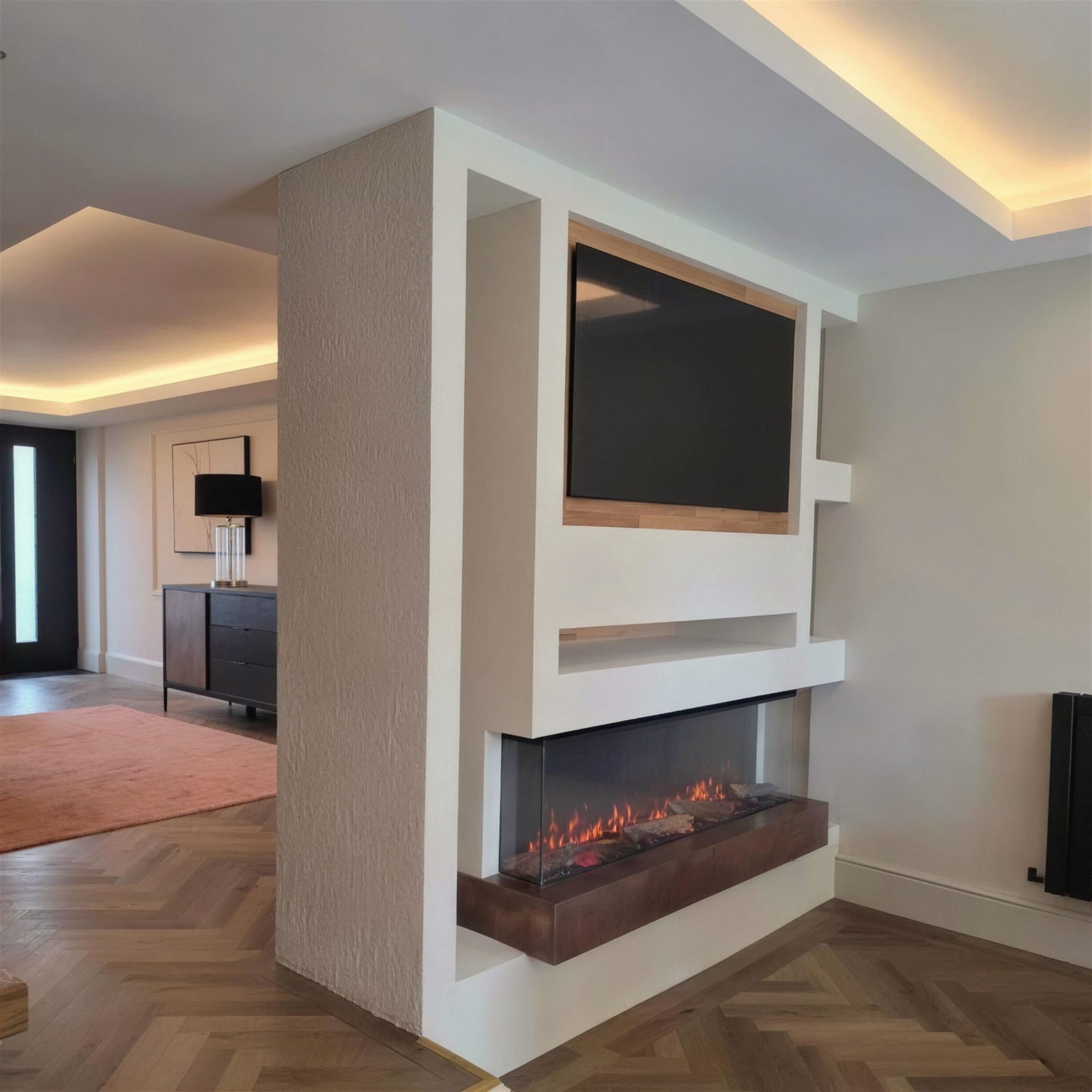 Wide, level view of a cream textured-marmorino media wall with recessed TV and lit three-sided fireplace, warm LED coffer glow above and herringbone oak floor grounding the frame.